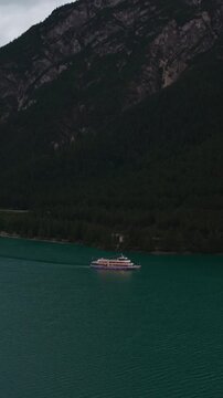 Passenger Cruise Ships Operate Over Lake Achensee, Surrounded By Mountain Scenery In Tyrol, Austria. Vertical, Aerial Shot