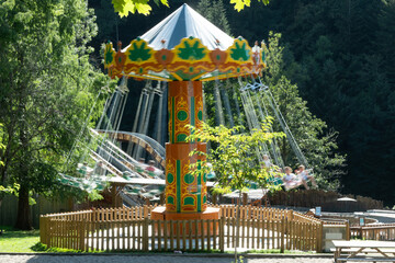 Carousel swing ride spinning in a park © JBN