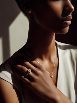 Jewelry is shown in a simple setting with focus on light and texture highlighting a womans hand and neck during a quiet moment in daylight