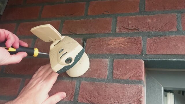 Installing a surveillance camera above the entrance to the house for security at home