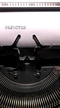 Vertical Macro Shot of Vintage Typewriter Typing the Word REJECTED