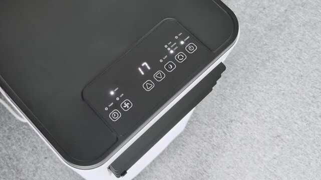 Adjusting temperature and fan speed on a portable air conditioner for your room setup