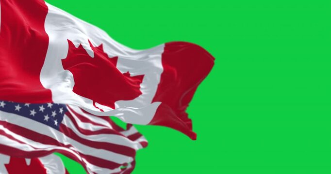 Canada and american national flags waving isolated on green background