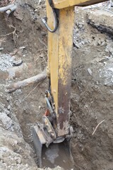 Excavator bucket digging trench at construction site © Анна Хмеленок