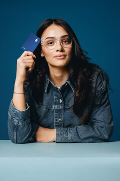 Membership themes come through as the woman presents a credit card in blue