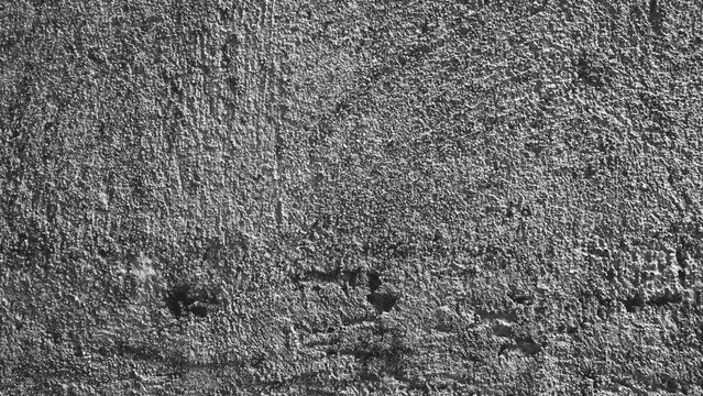 Black and white rough plaster texture with pronounced surface grain and natural imperfections, providing an authentic aged wall background.