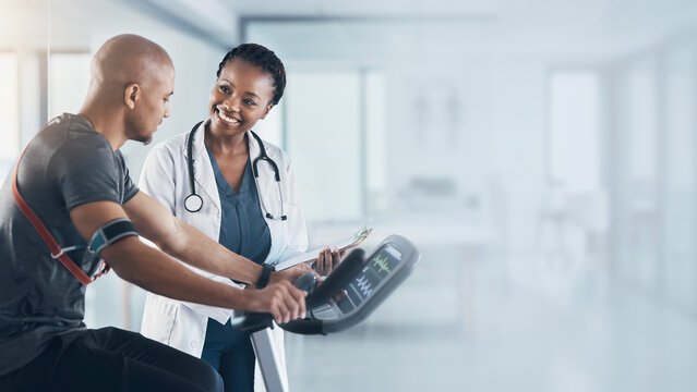 Female doctor monitoring patient on exercise bicycle during cardiac stress test background banner