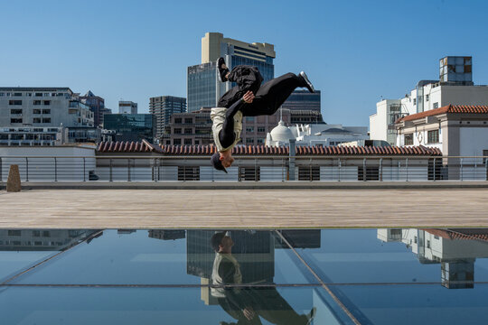 man doing a backflip in the city