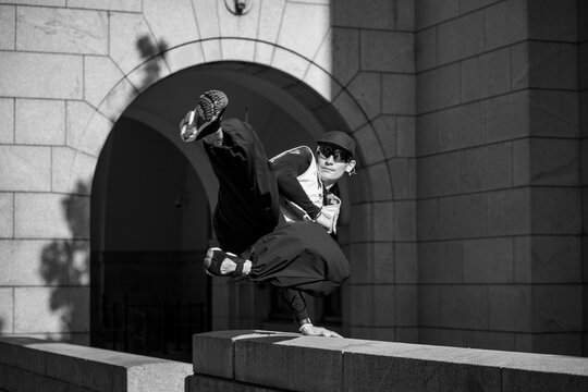 action shot of a parkour athlete in the city doing parkour free running