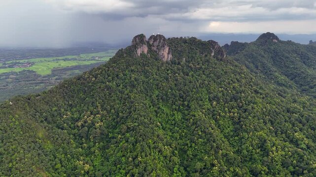 White Wat Chaloem stupas on summit rock spires in Thailand landscape