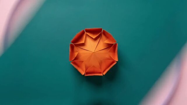 Origami paper rosettes transforming and unfolding on colorful backgrou