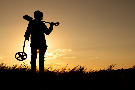 Ready for Adventure, Metal Detectorist Posing with Gear Against the Sun