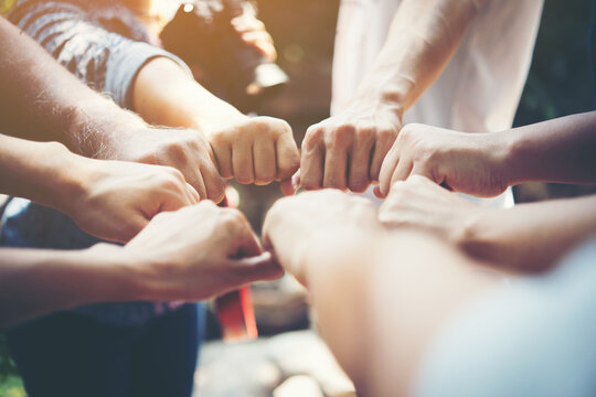 Diverse hands joined in a fist bump circle symbolizing strength, success, and professional meeting unity