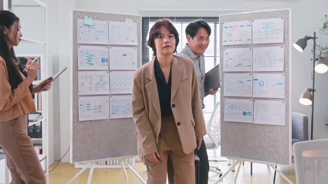 Asian Business Team Walking in and Posing for Portrait in Modern Office.