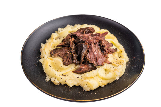 German Braised Beef Cheek, Slow cooked meat with smashed potatoes on a plate isolated on white background. top view