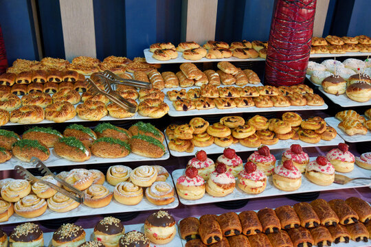 Assorted sweet and savory bakery pastries displayed on a rich hotel buffet table
