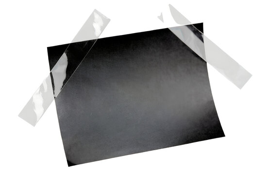 Blank black sticky note secured with transparent tape strips isolated on transparent background, dark stationery paper, office memo, minimal commercial PNG asset