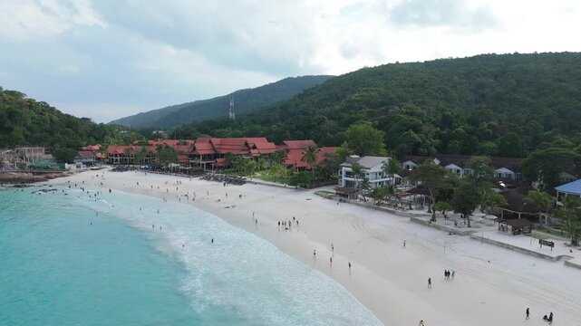 Aerial view of scenic tropical cove with white sand beach and lush rainforest mountains, Redang Island, Malaysia