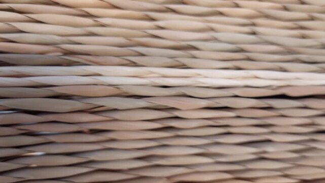 Detailed texture of woven straw basket background with selective focus