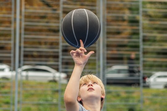 Child Practicing Basketball Skills Outdoors
