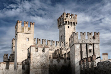 Ancient white stone castle with rectangular towers on sunny day, Sirmione, Lake Garda, Italy © Igor