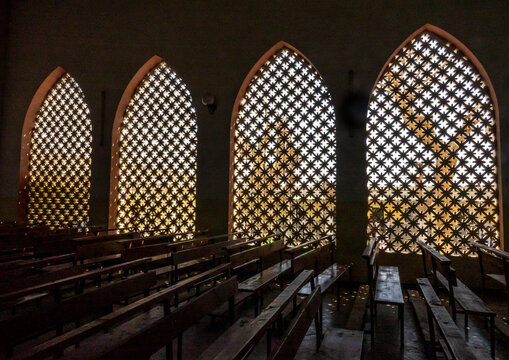 Interior view of a church nave with pierced arched windows and wooden pews, Benguela Province, Benguela, Angola