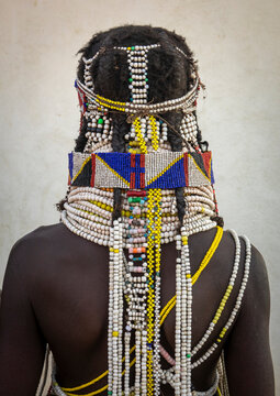 Back view of a Handa woman wearing a wide beaded collar and layered necklaces, Huila Province, Hoque, Angola