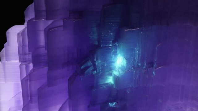 Translucent purple crystal structure with blue glow in an abstract dark setting