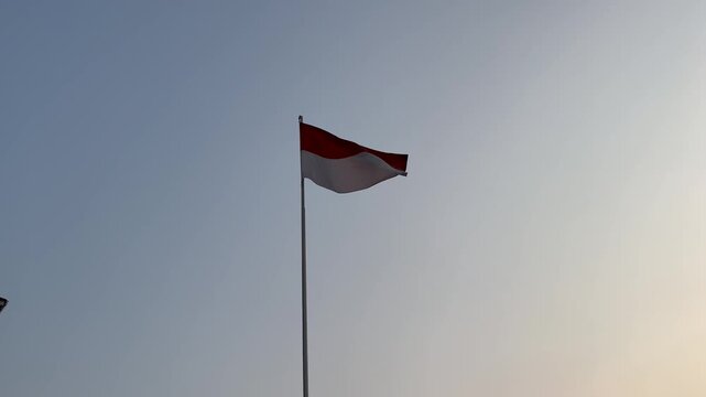 Indonesian National Flag Waving Proudly on Tall Pole