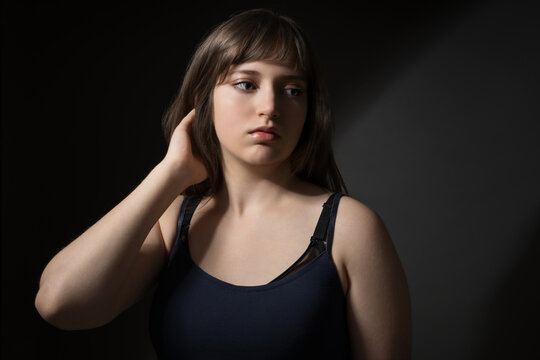 Beautiful Teenage Girl Posing for Beauty Portrait on Dark Background