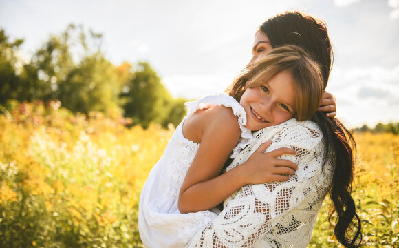 Mother having great moment with daughter on sunset time
