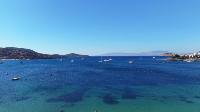 Drone rising above palm trees to reveal Bodrum beach in T&uuml;rkiye