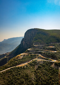 Aerial view of the winding hairpin road descending Serra da Leba with buses climbing the switchbacks, Huila Province, Humpata, Angola