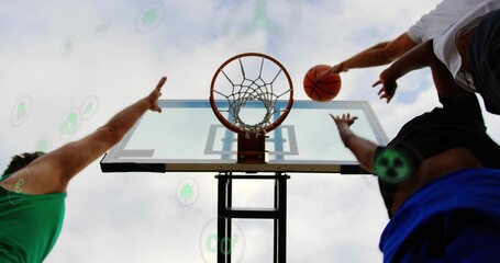 Reaching two players contesting basket at park court, in athletic gear and holding orange ball © vectorfusionart