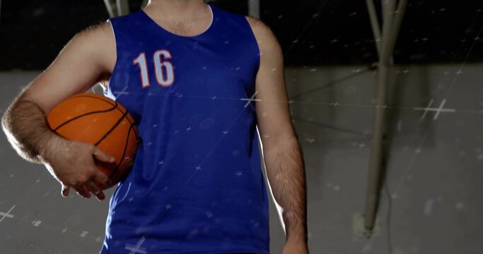 Holding adult male hoops player wearing blue sleeveless jersey 16 holding orange basketball in gym