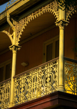 Sunlight illuminates the ornate cast-iron balcony columns and arch of the Palacio de Ferro, Luanda Province, Luanda, Angola