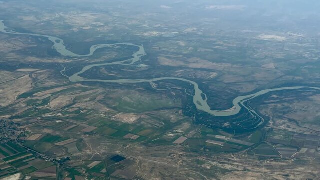 River winds through patchy farmland below