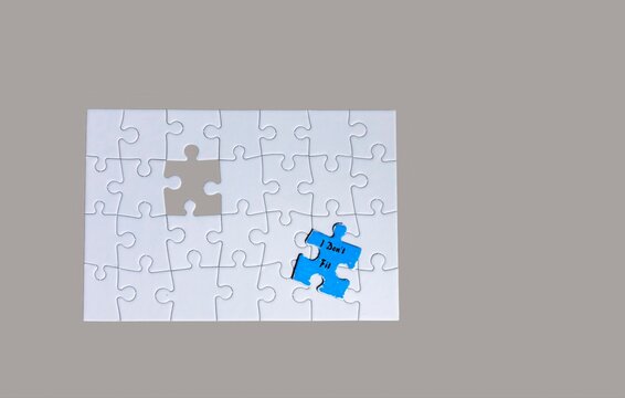 Puzzle Pieces on a Light Gray Background With One Blue Piece Near a Missing Spot
