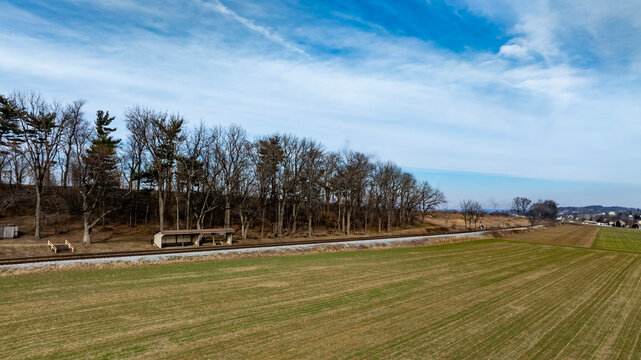 Railway Tracks Stretch Through a Peaceful Countryside Landscape on a Sunny Day