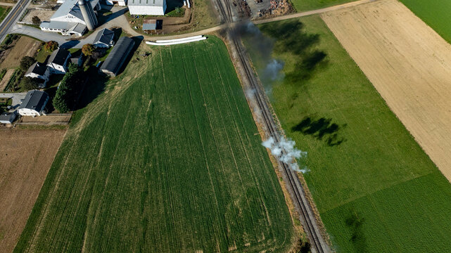 Smoke Rising From the Railway Near a Rural Landscape During a Clear Day