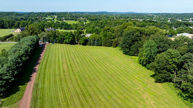 Expansive Green Landscape With Neatly Trimmed Grass and Distant Hills in Summer Sunshine