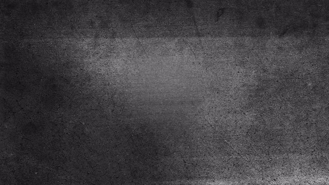 Abstract dark gray grunge textured background with subtle light transition.