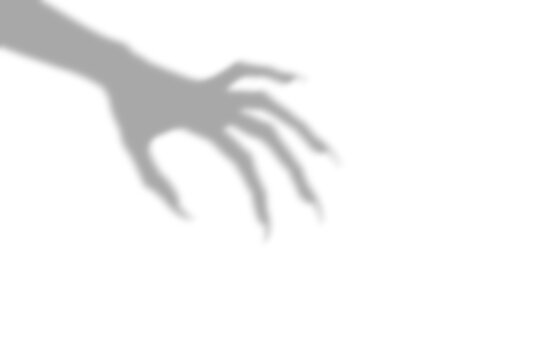 A dark scary shadow of a clawed monster hand reaching out from the side presented as an isolated object on a isolated on transparent background