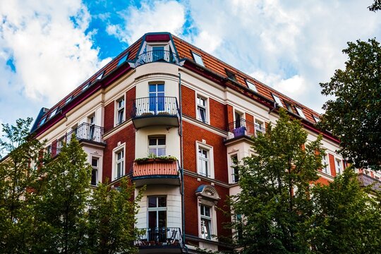 Ornate brick building with balconies and dormer windows