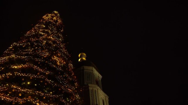 Kyiv Ukraine The main Christmas tree of the country near St. Sophia Cathedral, 11th century. Christmas lights at night. Bell tower square December Winter copy space background