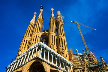 Fototapeta premium Sagrada Familia cathedral under construction against blue sky
