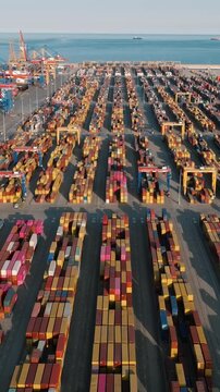 Aerial view of Valencia cargo sea port terminal with stacked colorful shipping containers and cranes pattern international logistics trade video stock