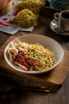 Asian Dry Noodles (Mie Ayam) with Roasted Meat on Rustic Table