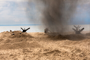 A World War II reenactment. A battlefield. Explosions and American soldiers on the beach. Smoke and dust. © krysek