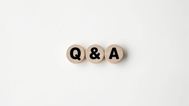Wooden circles with the text Q and A isolated on white background. Useful for conceptual business support and customer service communication topics.
